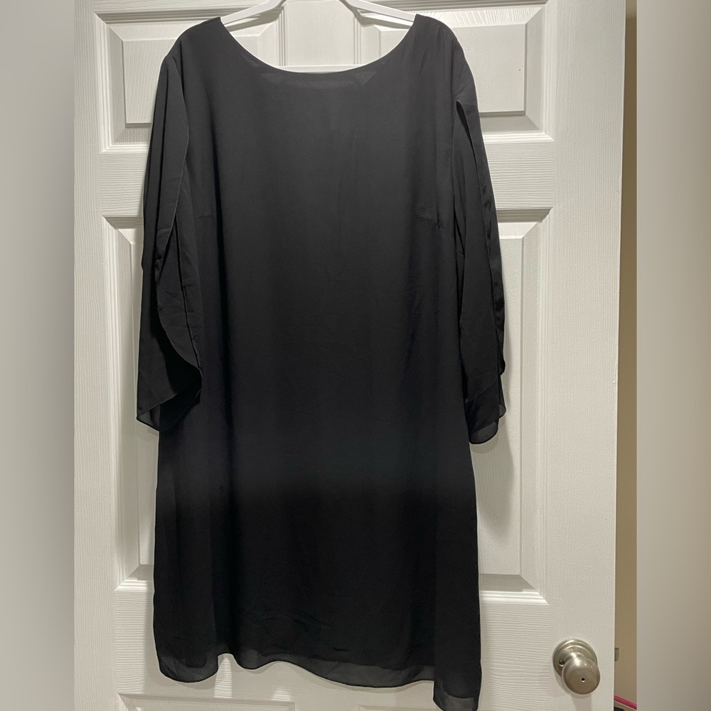 Black dress with 3/4 length sheer sleeves that are split from the shoulders down